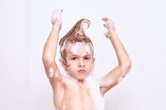 Boy with hair in mohawk in bathroom