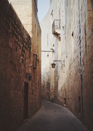 Empty pedestrian walkway with small balcony in Mdina, Malta