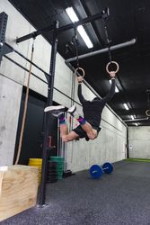 Man hanging on gymnastic rings