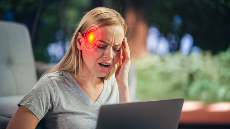 VFX Headache Render: Close Up of a Female Working on Laptop Computer and Experiencing Discomfort and Migraine.
