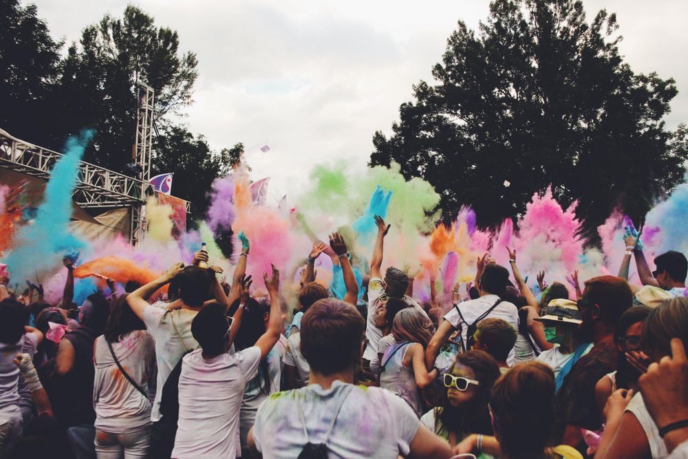 People splashing colors in nature