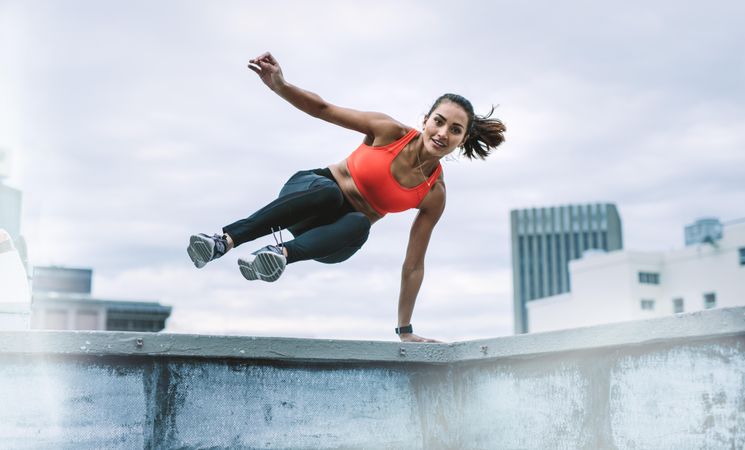 Woman in fitness wear doing fitness training on rooftop