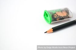 Sharpened pencil next to sharpener on table with space for text 0yX6v1