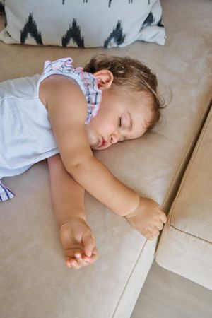 Adorable toddler sleeping on sofa