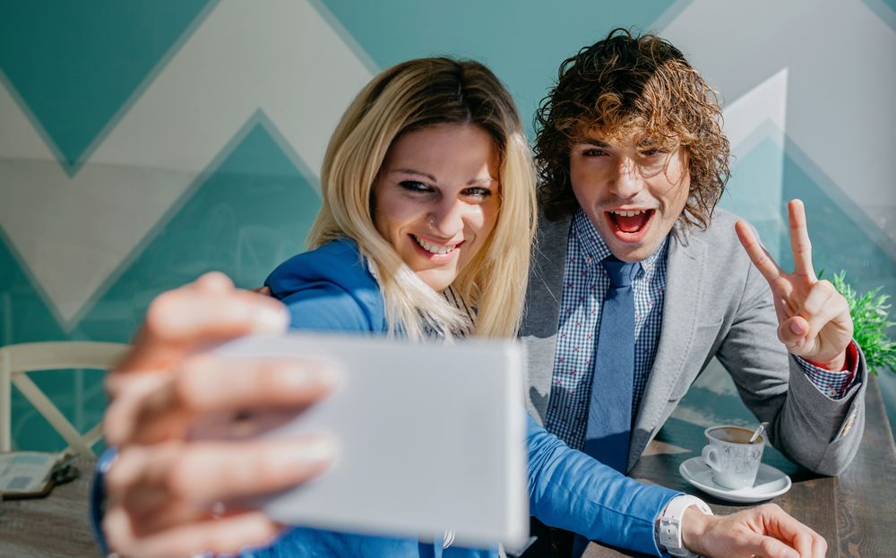 Coworkers taking a selfie celebrating success