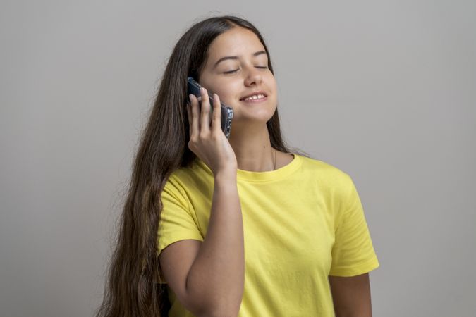 Phone call: young woman talking on phone, happy conversation, a smartphone user in casual style.