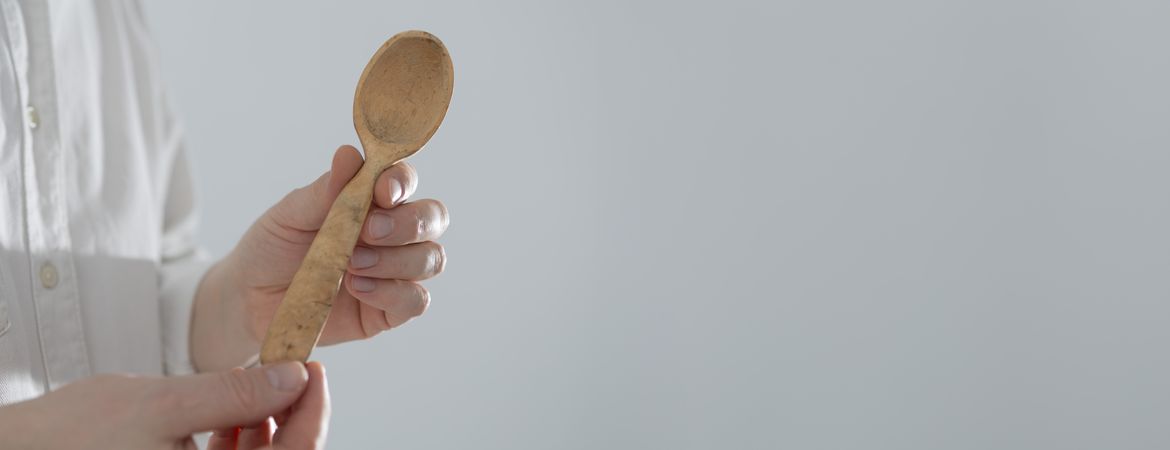 Man holding handcrafted wooden spoon