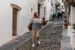 Woman walking in narrow streets with map