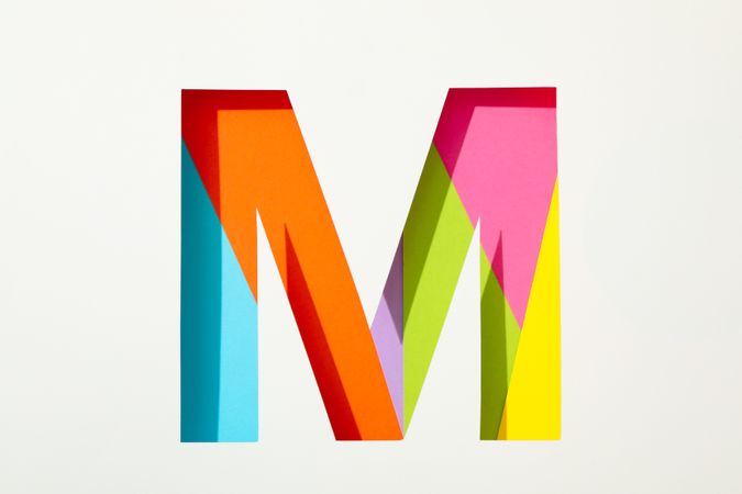 Multicolor letter M on blank background, space for text