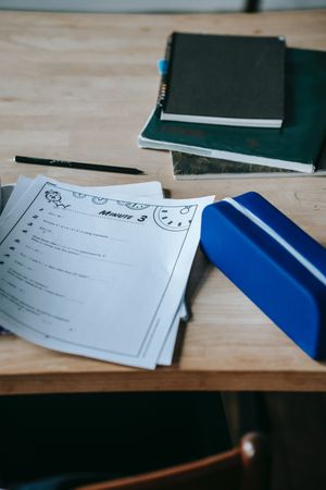 Notebooks and checklist on wooden table