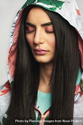 Woman with long brunette hair pictured in colorful printed floral hood 48W3Y5