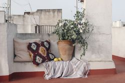 Cozy sitting area at the roof top, bench with Mexican pattern cushions