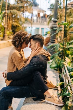 Young couple embracing on bench