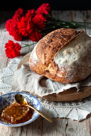 Sourdough bread near flowers and honey