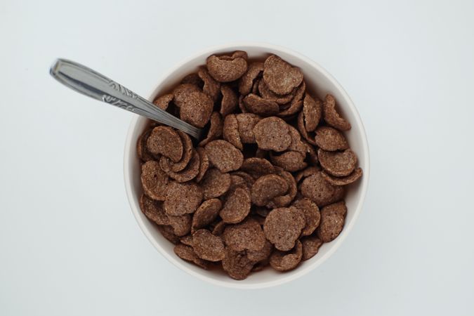 A bowl of chocolate flakes on a blank background