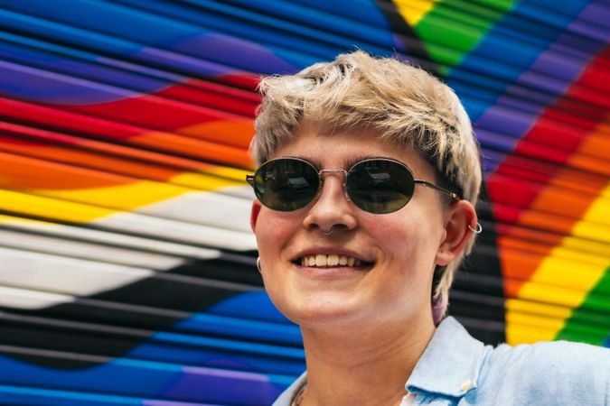 stylish young woman portrait on a background with lgbtqia colors