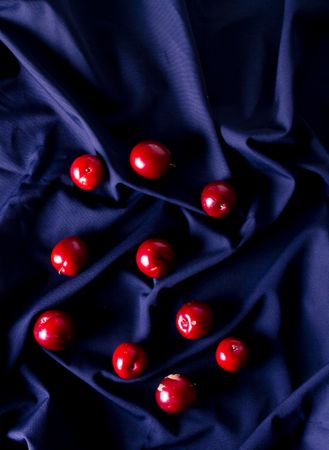 Fresh red plums on blue cloth