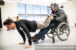 MONTREAL, QUEBEC, CANADA – April 14 2019- Man in wheelchair holding feet of man doing plant bGPQ20