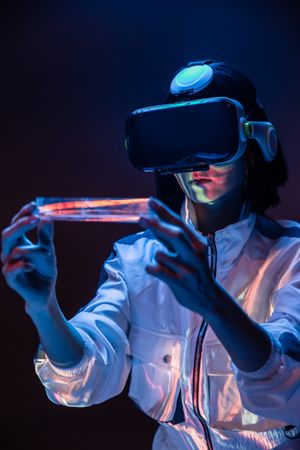 Woman touching air in VR glasses