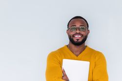 Smiling Black man with laptop