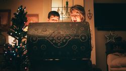 Mother and son opening magic chest on Christmas Day