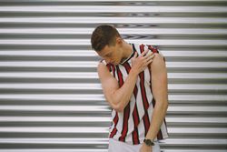 Man leaning on steel garage door