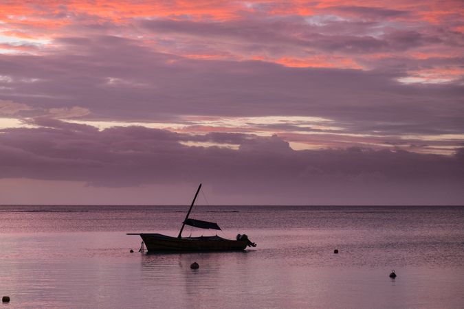 Single boat in Indian Ocean at sunset