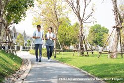 Smiling male and female jogging on walkway 4ZlYO0