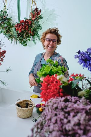 Laughing woman with bouquet of trachelium flowers