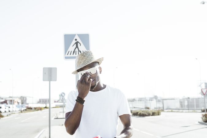 Modern man wearing sunglasses in sunlight