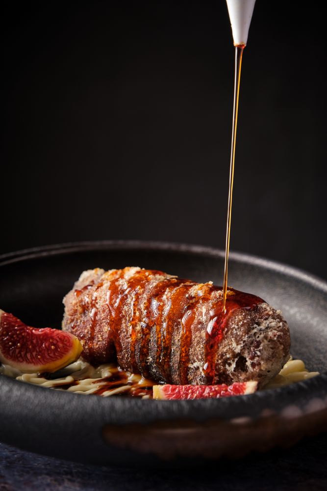 Delicious pork meat with sauce served in plate