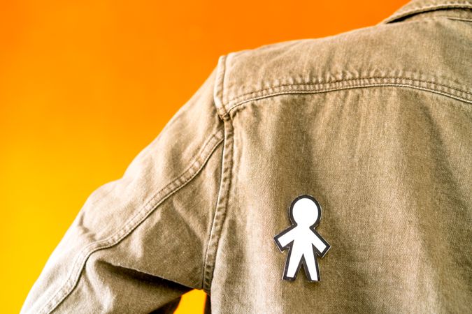 man with funny paper toy on jean jacket