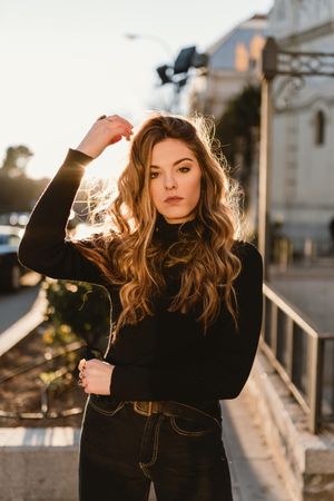 Stylish woman standing near metro station
