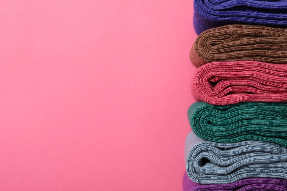 Casual clothes and wearing concept - socks, clothes for foot