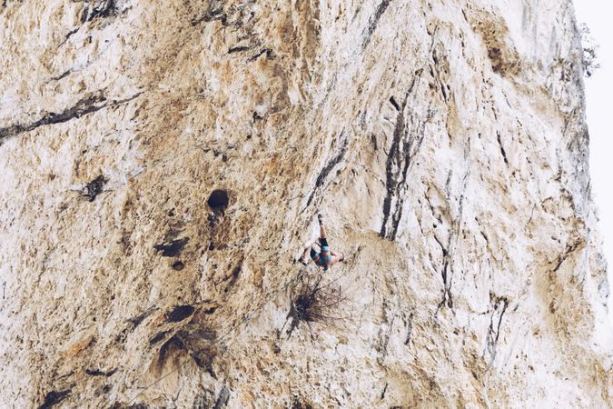 Anonymous man climbing rock