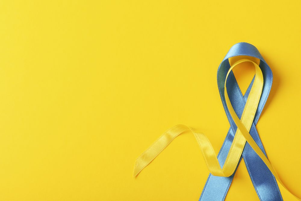 Ribbon in Ukrainian flag colors on yellow background with copy space