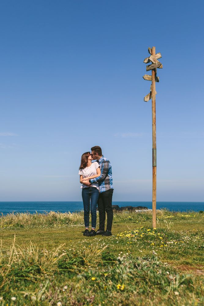 Couple kissing embraced by a direction sign