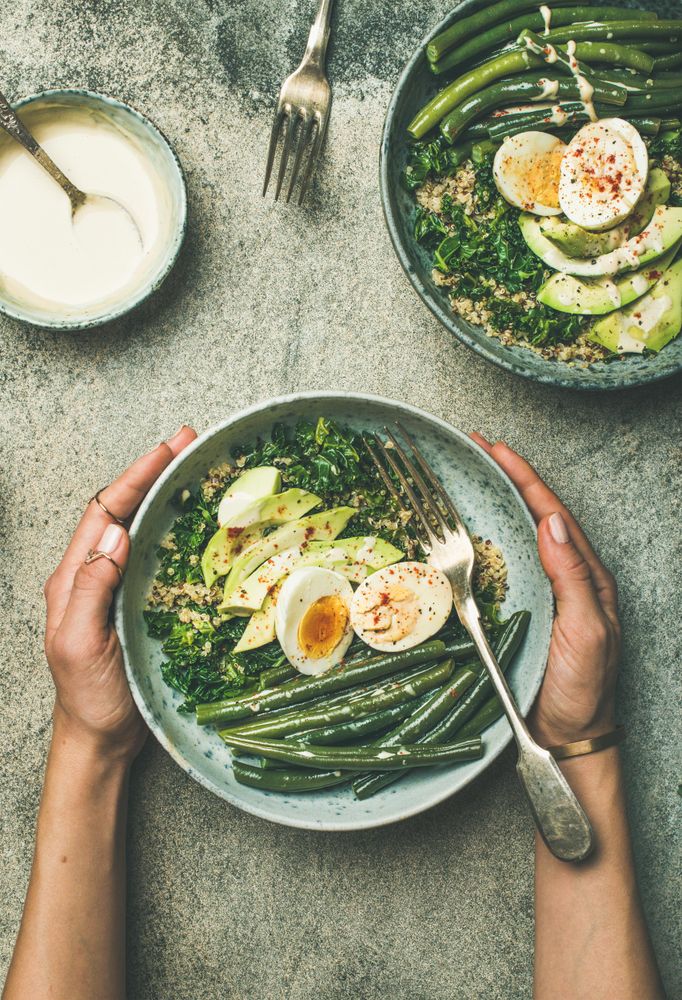 Female hand’s holding healthy lunch bowl