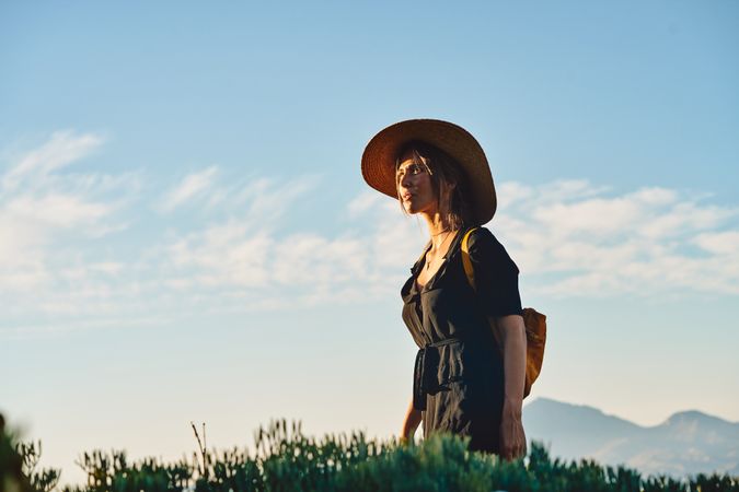Woman traveler in straw hat walking