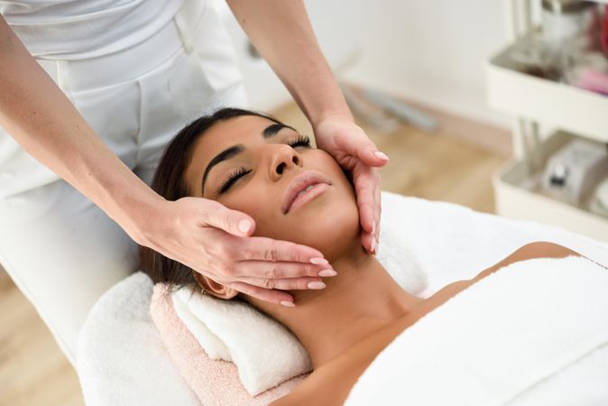 Woman receiving a facial from a professional