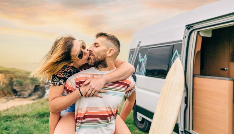 Loving couple outside motorhome with beautiful view