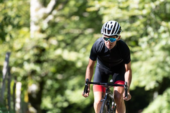 Professional cyclist riding bike in park