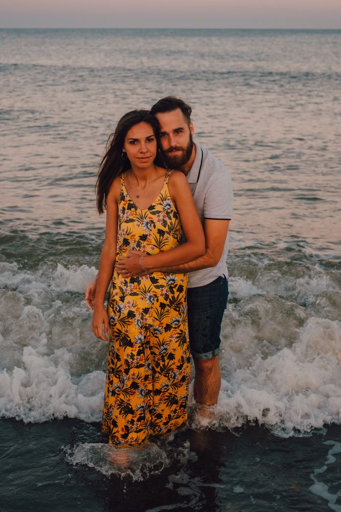 Loving couple embracing happily on sandy beach