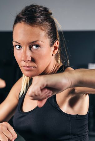 Portrait of woman doing boxing class in gym