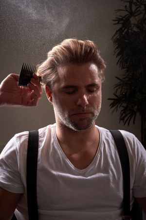 Portrait of man getting haircut