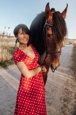 Young woman with horse on ranch
