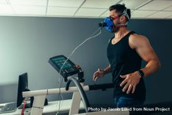 Athlete examining his performance in sports science lab running on treadmill 0Ky1Z4