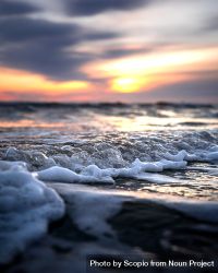 Macro photography of ocean waves crashing on shore during sunrise 0LpAg0