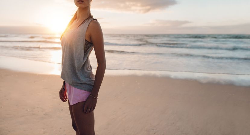 Fitness woman standing on the beach