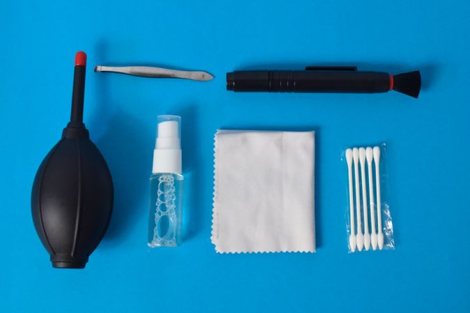 Top view of lens cleaning kit on blue table